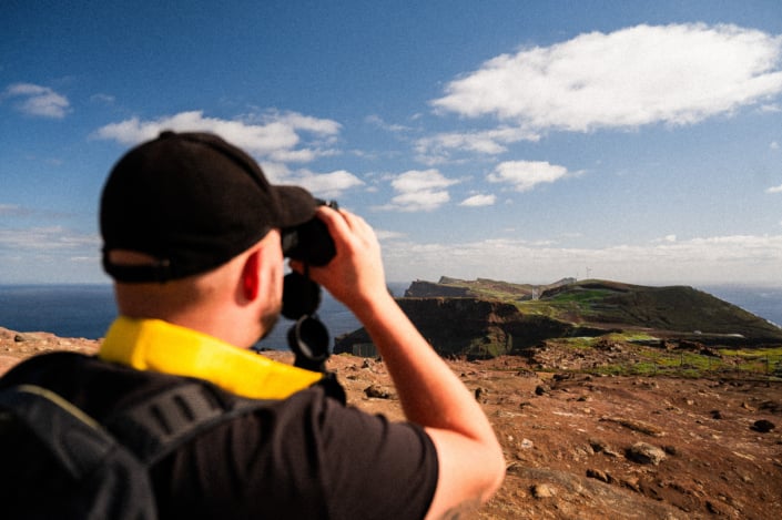 Christoph looking at the stunning landscape of Madeira island with binoculars