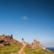 Christoph on a hiking trail, blue sky, rocky desert