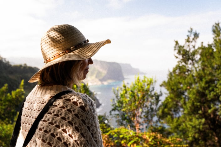 A female digital nomad with a white hat in the nature