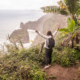 Female Digital Nomad spreading her arms at a stunning ocean view on Madeira island